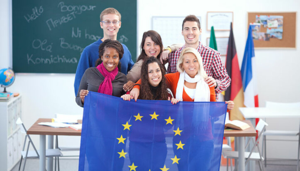 Group of students standing together in language class and holding flags of European Union.See more STUDENTS at LANGUAGE CLASS or FOREIGN LANGUAGE COURSE images. Click on image below for lightbox.
